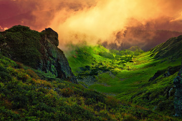 mountain landscape with abstract stone giant and fog over valley