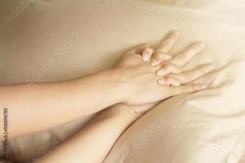 Fotografie, Obraz Close up hands of a couple having sex on a bed