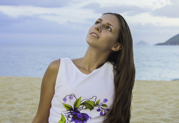 girl sitting in dress on the beach. sunset. sea.