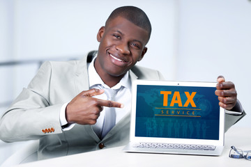 Sticker - Online Tax payment concept. Handsome businessman with laptop, close up