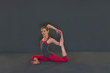 © Connect Images - Woman in yoga pose on grey background