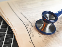 Financial Health Check: Stethoscope On Newspaper With Financial Markets For Investing