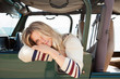 © Connect Images - Young woman leaning out of jeep window