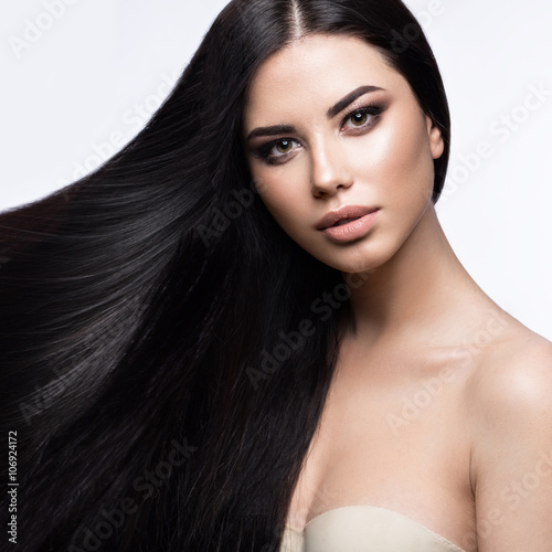 Beautiful brunette girl in move with a perfectly smooth hair, and classic make-up Lerretsbilde