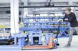 © Connect Images - Mid adult male moving products on pallet jack in engineering plant