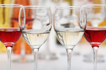 Wall Mural - Wine glasses with red and white wine, closeup