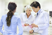 Pharmacists Advising Customer On Medication