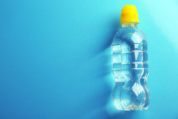 Canvas Print - Bottled water on the blue background, top view