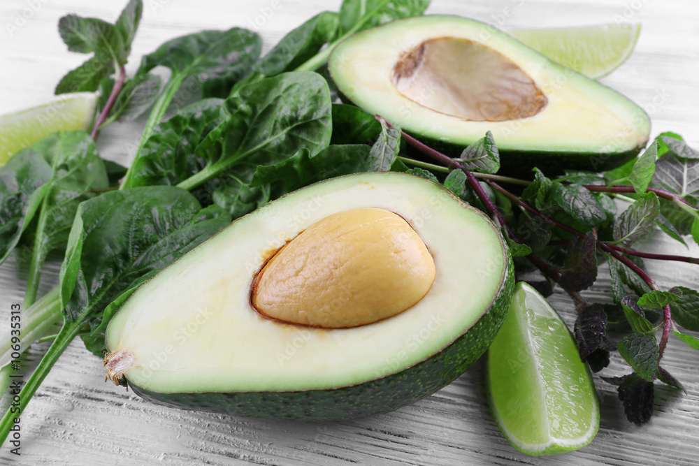 Avocado and lime on wooden background