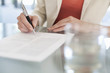 © Connect Images - Cropped image of businesswoman signing paperwork
