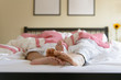 © Connect Images - Surface level image of young couple in bed, feet out of duvet