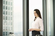 © Connect Images - Portrait of businesswoman in high rise office