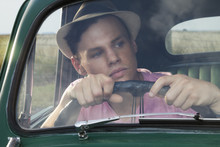 Young Man Looking Through Windscreen Of Vintage Morris Minor