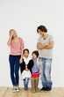 © Connect Images - Studio shot of couple with son and daughter in oversize clothes