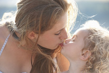 Portrait Of Young Girl Kissing Older Sister