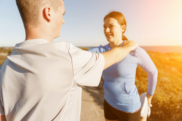 Young couple on beach training together