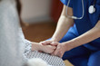 © Connect Images - Cropped image of nurse holding patient's hand