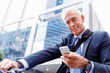 © Sergey Nivens - Successful businessman on bicycle with mobile phone