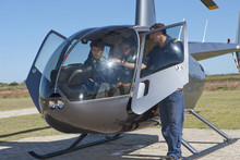 Flight Instructor Showing Student Pilots Flight Deck Of Helicopter