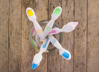 toothbrushes on wood plank background, soft focused, top view