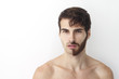 © anderpe - Man without a shirt, standing in front of a camera on a white background with half of his face with scruffy beard and messy hair, the other half has trimmed beards.