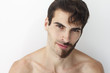 © anderpe - Man without a shirt, standing in front of a camera on a white background with half of his face with scruffy beard and messy hair, the other half has trimmed beards.