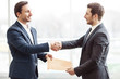 © zinkevych - Positive business partners shaking hands