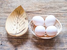 Duck Eggs In Coconut Cup On Wood Background