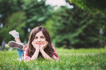 Wall Mural - beautiful woman lying on green grass
