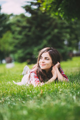 Wall Mural - beautiful woman lying on green grass