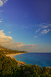 Beautiful view of Ionian sea with sandy beach in Albania with a green bushes foreground