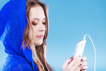 Wall Mural - young woman with smart phone listening music