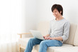 © taka - young asian man using laptop computer