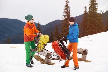 Wall Mural - Two hikers in winter mountains