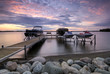 © PhotoImage - Boat dock at sunset with raised boats and jet ski's