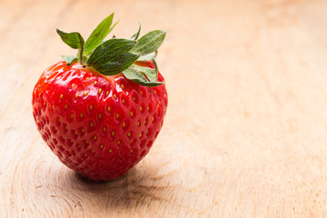 Red fresh strawberry fruit on wooden table.