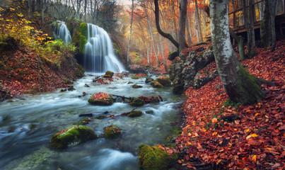Wall Mural - Beautiful waterfall in autumn forest in crimean mountains at sun