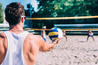 Beach volleyball player serving