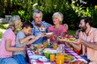 © WavebreakMediaMicro - Multi- generation family offering food at breakfast