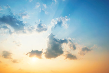 Wall Mural - Sky blue and orange light of the sun through the clouds in the sky survive.