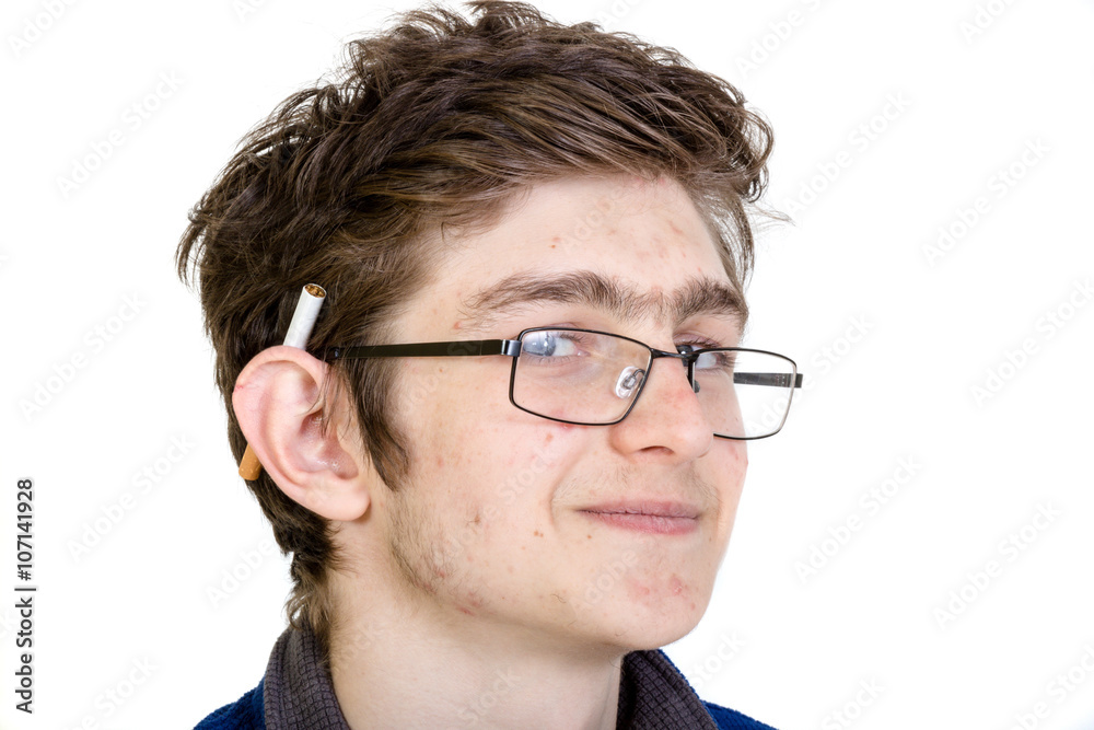 cigarette behind ear meaning Teen boy with a cigarette behind his ear Stock Photo
