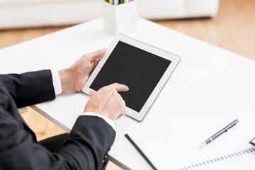Poster - Businessman using digital tablet at desk