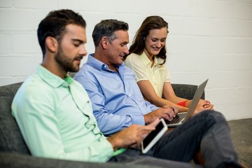 Aufkleber - Colleagues discuss using laptop and digital tablet