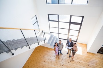 Wall Mural - Real estate agent showing new house to couple