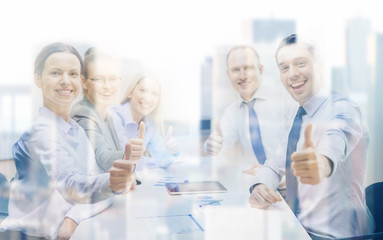 Canvas Print - business team showing thumbs up in office