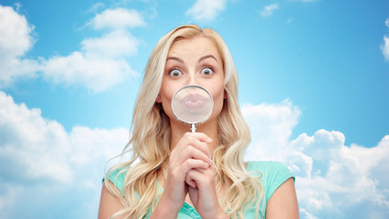 happy young woman with magnifying glass