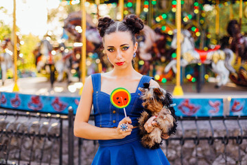 Wall Mural - Bright makeup beautiful girl with Yorkshire Terrier holding watermelon lollipop.