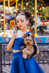 Wall Mural - Bright makeup beautiful girl with Yorkshire Terrier holding watermelon lollipop.