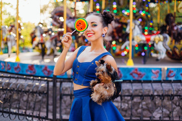 Wall Mural - Bright makeup beautiful girl with Yorkshire Terrier holding watermelon lollipop.