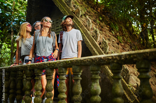 Fotografie, Obraz tourist exploring ancient jungle ruins in tropical rain forest on thailand adven